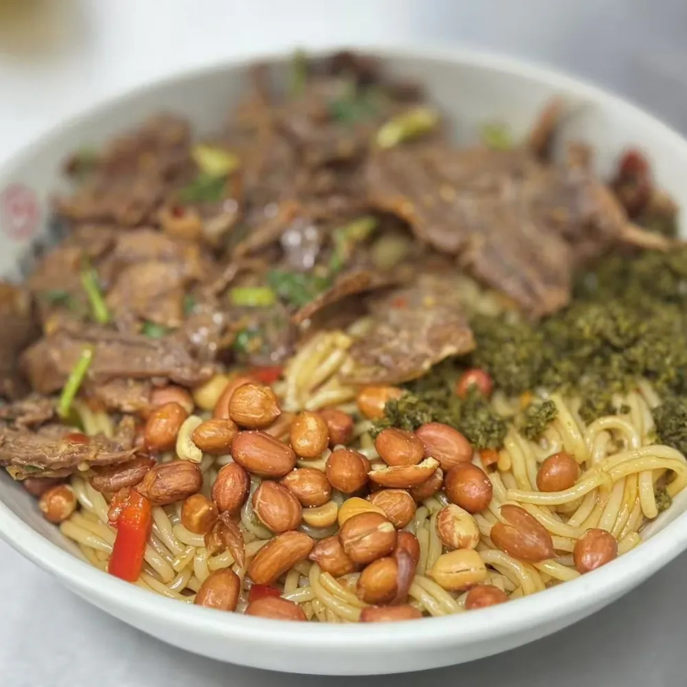 Dry mixed beef rice noodle topped with peanuts and herbs at Ten Seconds Yunnan Rice Noodle, a Chinese Restaurant in Syosset