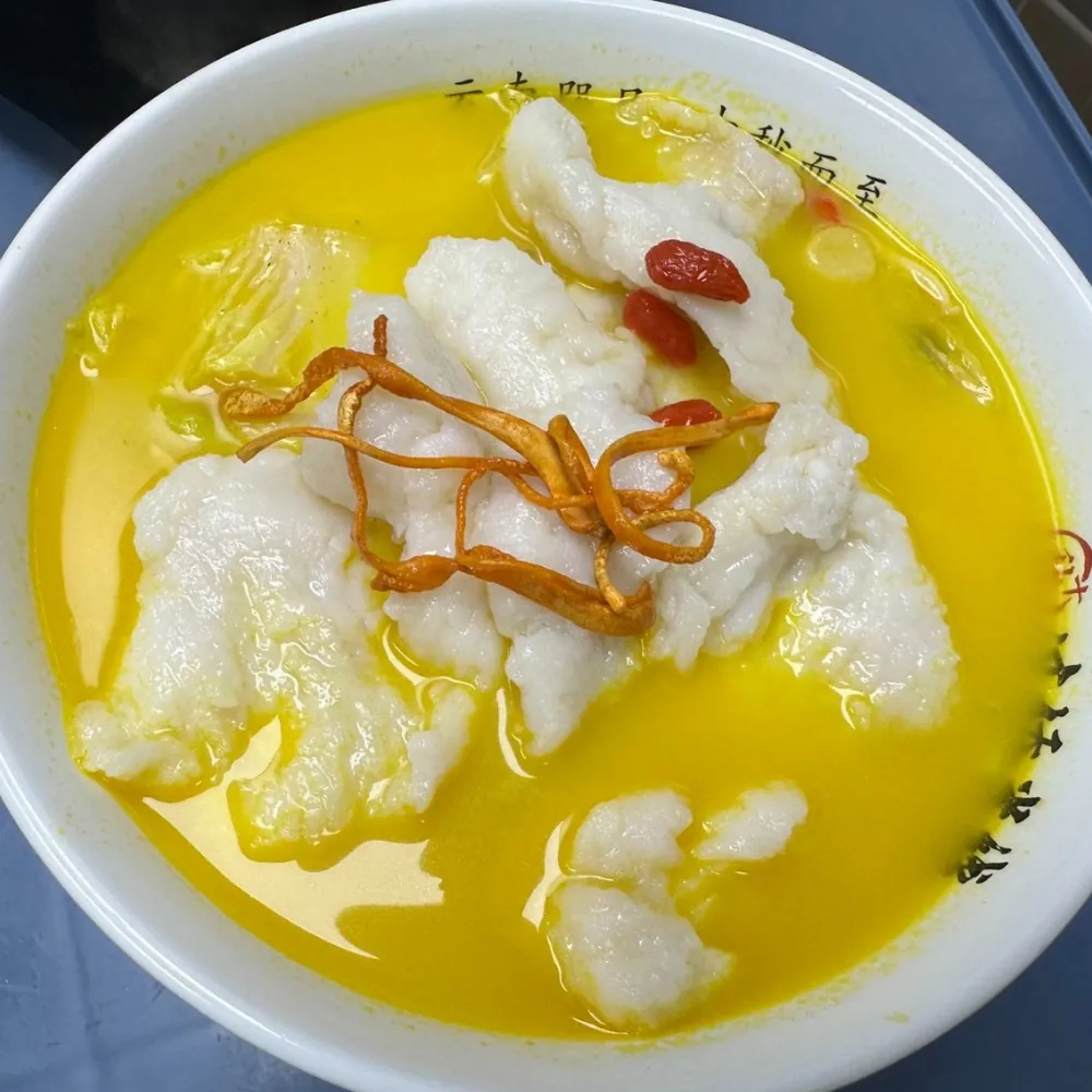 Golden soup fish fillet rice noodle with cordyceps flowers at Ten Seconds Yunnan Rice Noodle, a Chinese Restaurant in Syosset