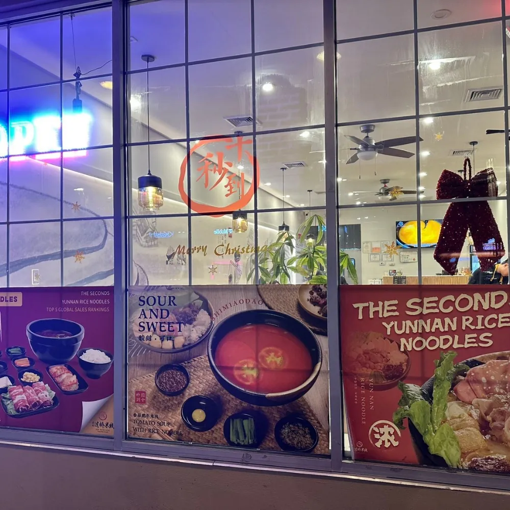 Restaurant storefront with Yunnan rice noodle posters at Ten Seconds Yunnan Rice Noodle, a Chinese Restaurant in Syosset